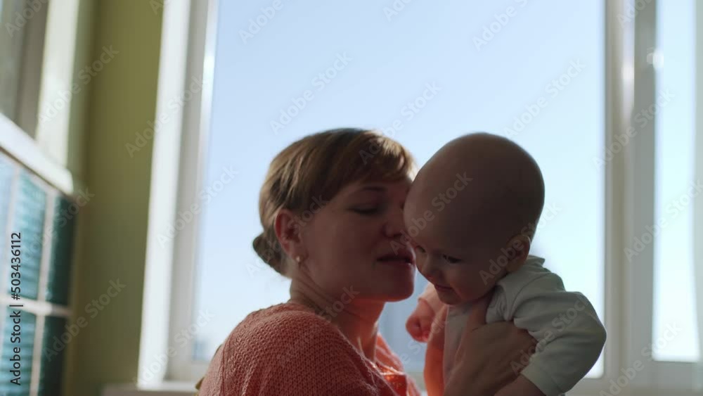 Happy young mother throws her baby up and kisses. Happy young mother throws her baby up and kisses.