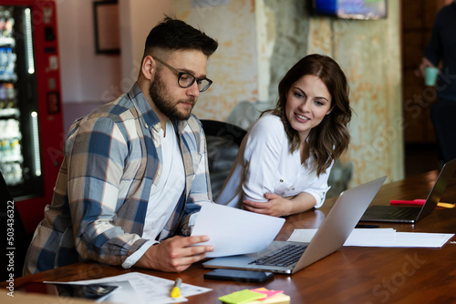 Colleagues in office. Businesswoman and businessman discussing work in office