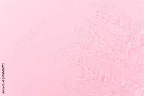 Close up macro Aloe vera gel cosmetic texture pink background with bubbles. Lemongrass gel skincare product. antibacterial liquid with aloe vera, moisturizing. Safe and environmental friendly.