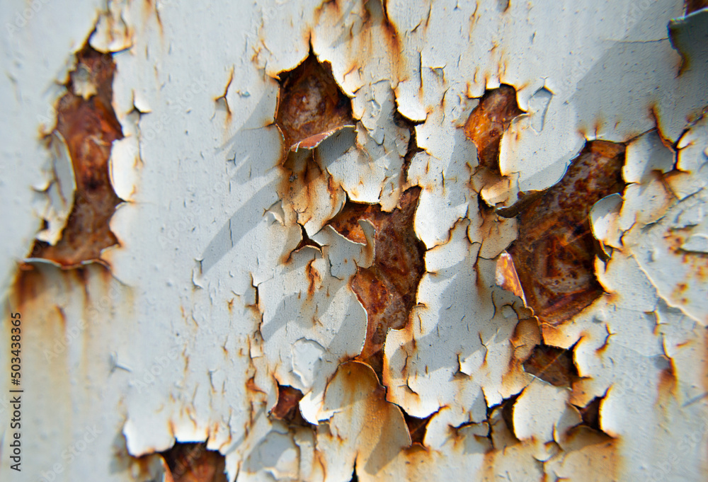 Hole chipped paint rusty textured, metal background. Extreme Close-Up Of Crumbling Paint Peeling Off From A Rusty Metal Plate.