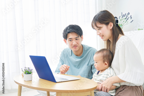 両親と赤ちゃん ノートパソコン リビング
