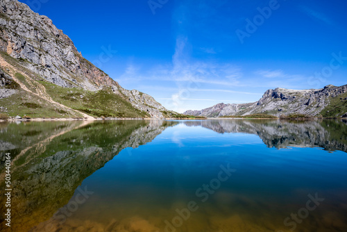Fototapeta Naklejka Na Ścianę i Meble -  Lago del Valle in the Somiedo Natural Park in Asturias, Spain. A dream environment where the mountains are reflected in the lake like a mirror. Nature in its purest state for hiking and tourism.