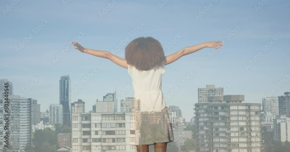 Animation of cityscape over african american woman with arms outstretched Animation of cityscape over african american woman with arms outstretched