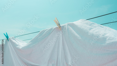 Drying bed sheets outdoor in hot summer air © Bits and Splits