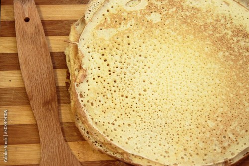 Stack of homemade pancakes on wood cooking board