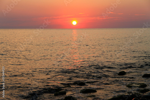 Subtropical sunset over sea. Tha Black sea seashore