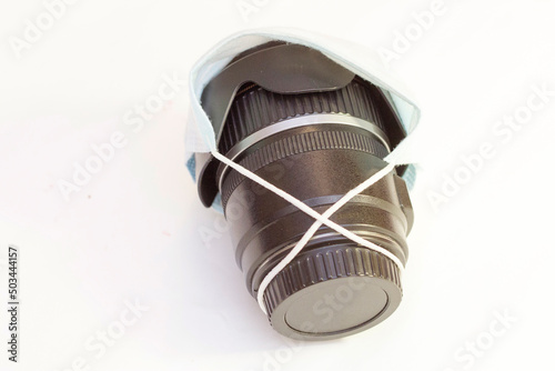 Optical lens for photo camera lies in a protective medical mask