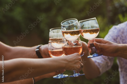 Party at sunset. Glasses with alcohol. Alcohol. Champagne with friends. Glasses of champagne in summer. Summer. Friends are relaxing at a party. Fun with proseco. dinner