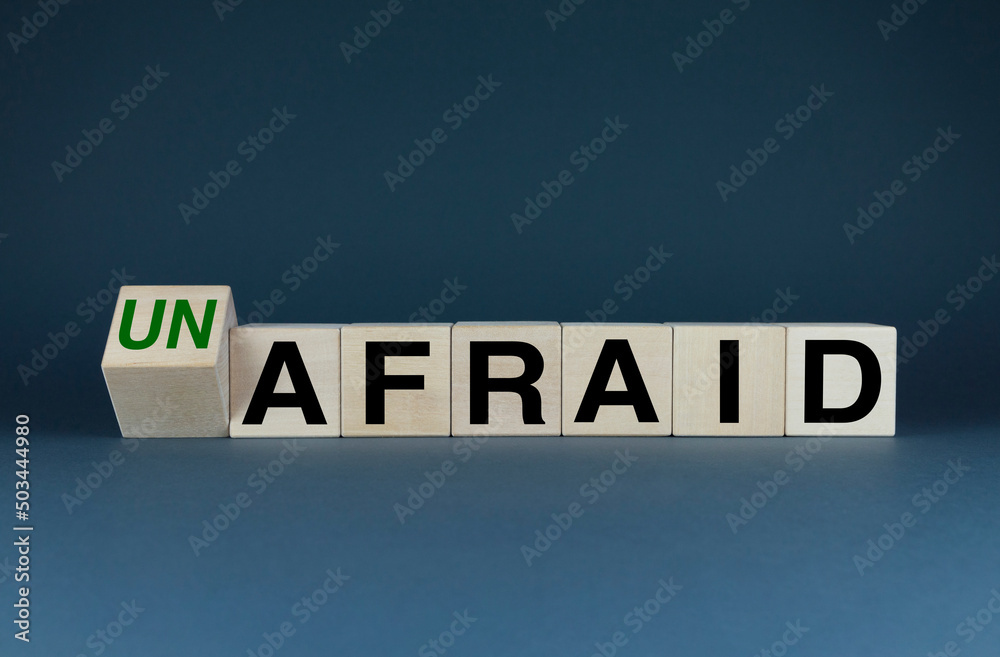 Obraz premium Cubes form the words Un afraid or afraid. Concept in business and lifestyle