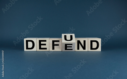 Cubes form words Defund or Defend. Defund and Defend concept