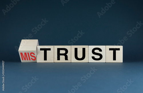Cubes form the words Mistrust or trust. The concept of trust in business and personal life