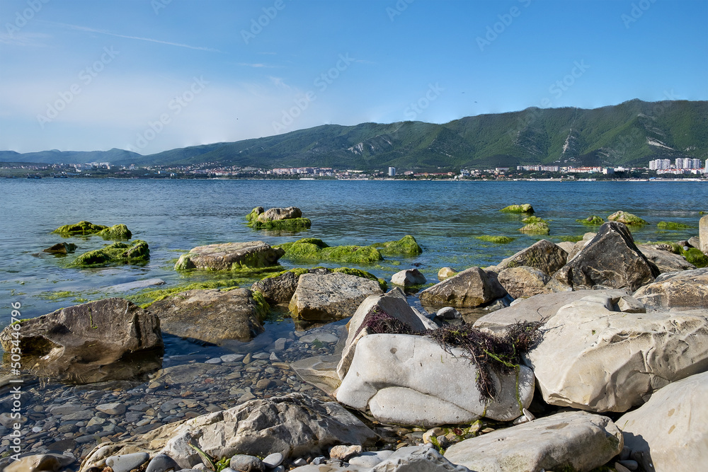 Rocky shore of the sea bay and mountain view