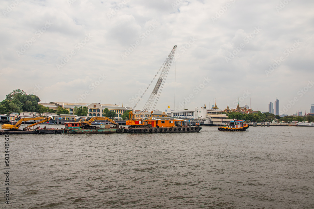 Tugboats with a cargo ship on the Chao Phraya River in Bangkok Thailand Southeast Asia