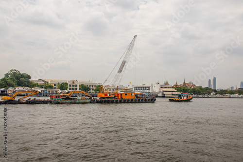 Tugboats with a cargo ship on the Chao Phraya River in Bangkok Thailand Southeast Asia