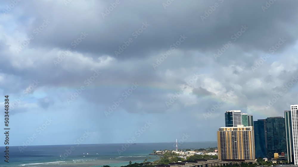 Long rainbow with dramatic clouds over the waikiki beach oahu Island, Hawaii year 2022 Long rainbow with dramatic clouds over the waikiki beach oahu Island, Hawaii year 2022
