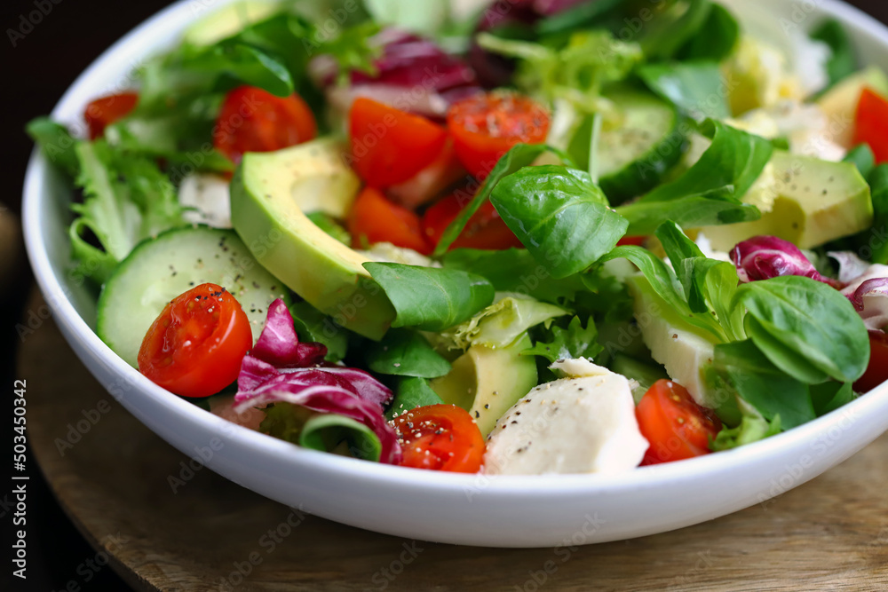 Healthy salad with vegetables and avocado. Diet food.