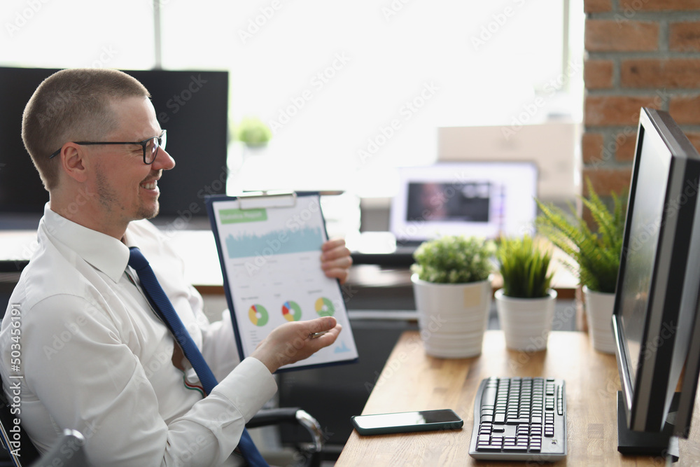 Businessman presenting financial report online to colleague, clever middle aged clerk in suit