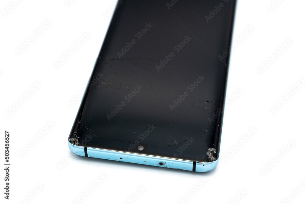Broken smartphone screen, destroyed and scratched display on isolated phone Broken smartphone screen, destroyed and scratched display on isolated phone