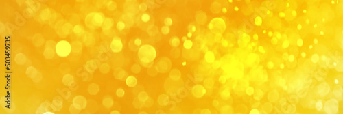 Bright yellow sparkling glitter bokeh background, banner texture. Abstract defocused lights header. Wide screen wallpaper. Panoramic web banner with copy space for design