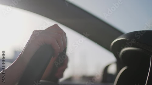 Female hands on the steering wheel. Woman driver, car in motion, close-up 4K 10 BIT