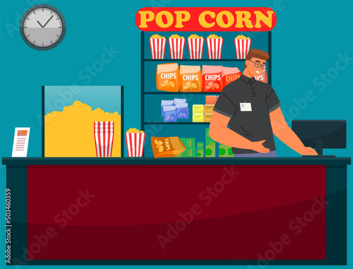 Man salls snacks and drinks for watching movie in cinema. Seller near stand with popcorn, chips and soda. Person works in food sales department of movie house. Cinema employee sells popcorn and drinks