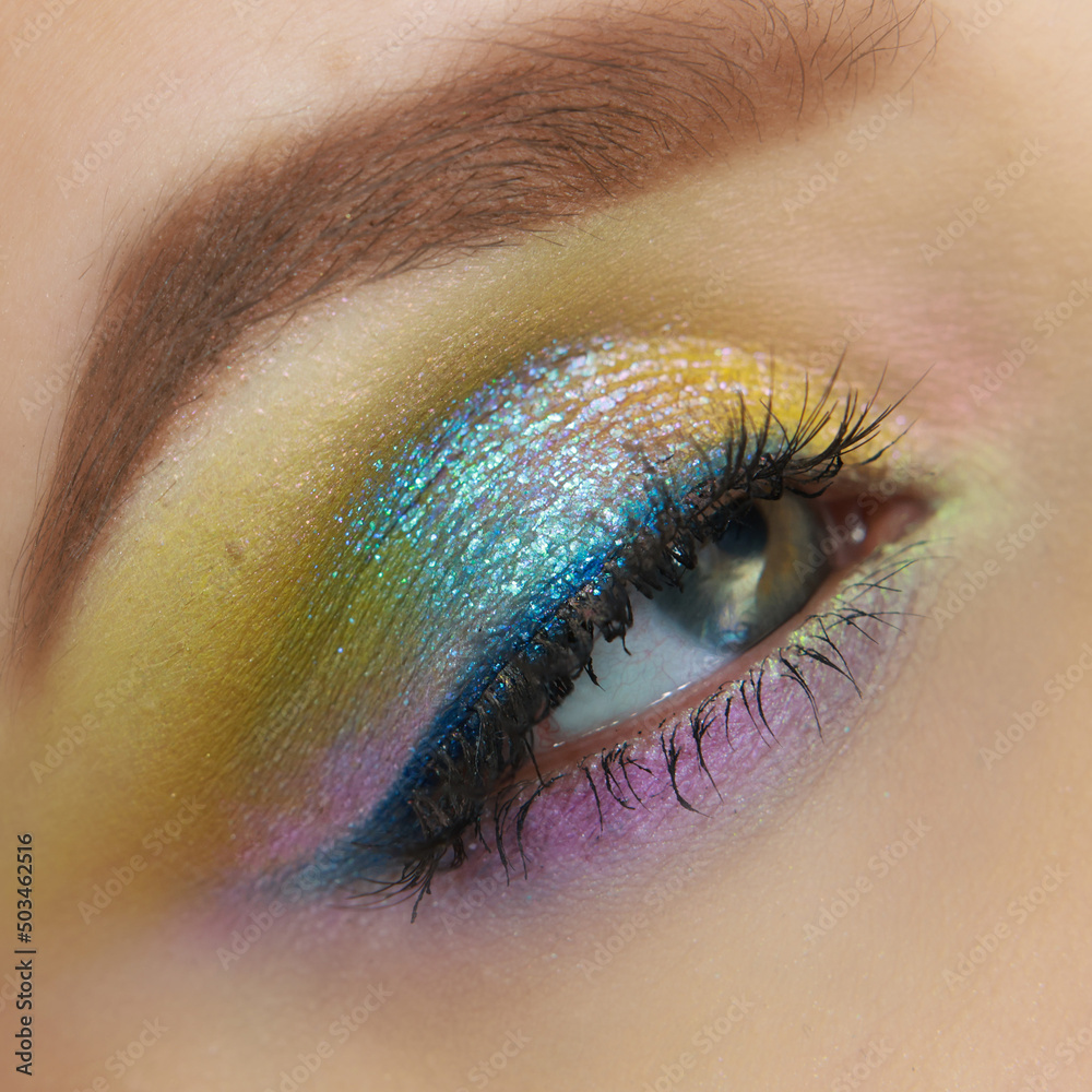 Stunning colorful shimmery eye makeup in colours of the rainbow. Pastel makeup. Shiny makeup Spring makeup - obrazy, fototapety, plakaty 