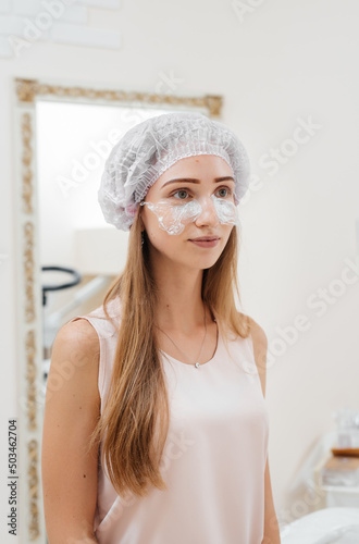 A young girl in a cosmetology office is undergoing facial skin rejuvenation procedures. Cosmetology..