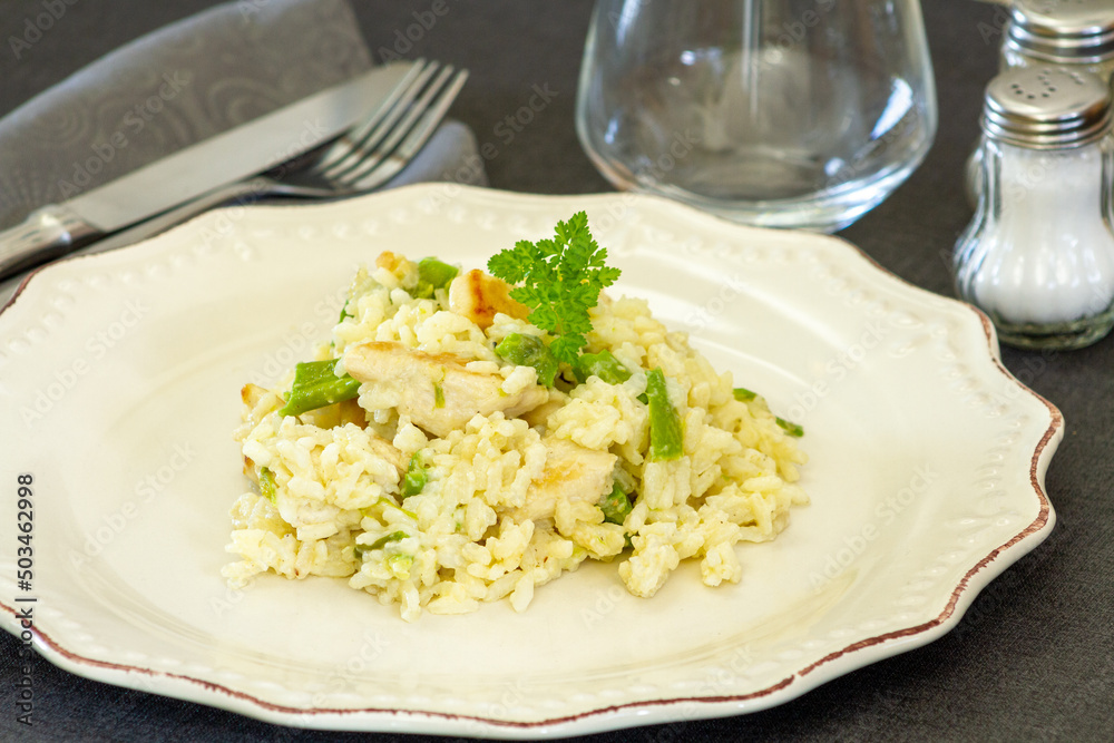 chicken and green asparagus risotto on a plate chicken and green asparagus risotto on a plate