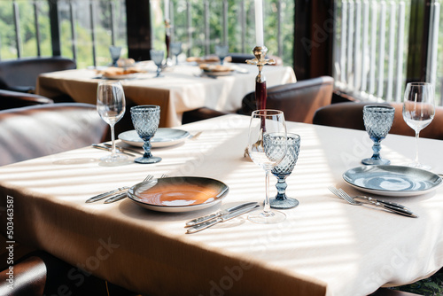 A beautifully laid table with exquisite dishes in a modern restaurant.