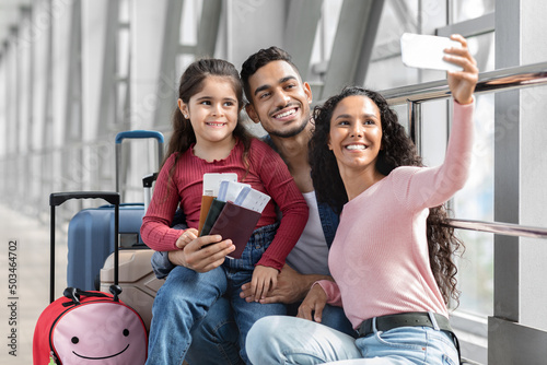 Airport Selfie . Happy Middle Eastern Family Of Three Taking Photo With Smartphone