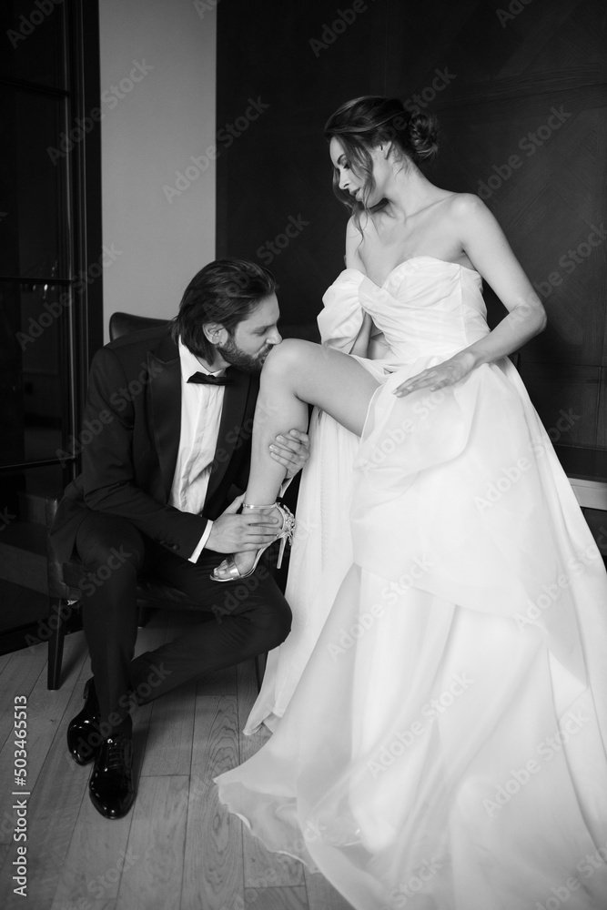 Young and beautiful couple, married and happy, man wearing tuxedo and woman wearing white dress