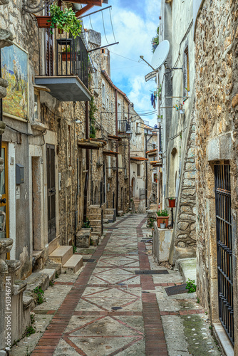 Characteristic alley of the town of Vico del Gargano. The ancient stone houses with the stairways to access and the cobbled street. Vico del Gargano, Foggia province, Puglia, Italy, Europe