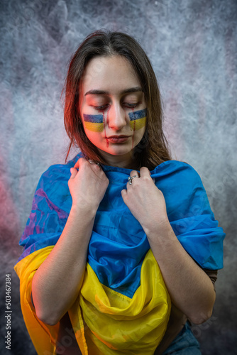 the Ukrainian woman in the national flag shows all the emotions and hope for peace