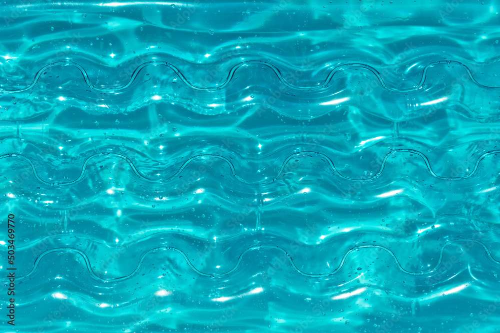Texture of inflatable aqua color mattress on the water