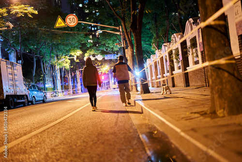 Photography SHANGHAI, CHINA - APRIL 26, 2022: A couple walked their dog in lockdown after th