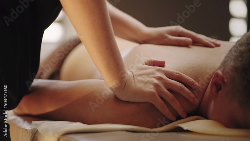 relax massage in spa salon, professional physician is massaging back of man, manual therapy and osteopathy