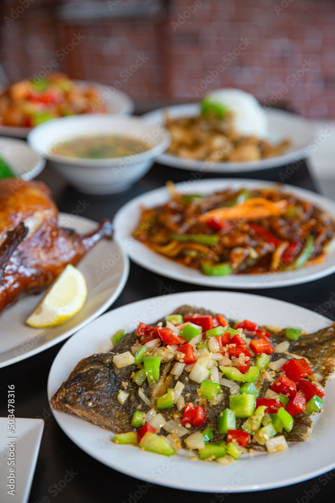 Food platter combo set of traditional Cantonese yum-cha Asian gourmet cuisine meal food dish on the white serving plate on the table, includes dishes of duck, pork, fried flounder fish, chicken Food platter combo set of traditional Cantonese yum-cha Asian gourmet cuisine meal food dish on the white serving plate on the table, includes dishes of duck, pork, fried flounder fish, chicken