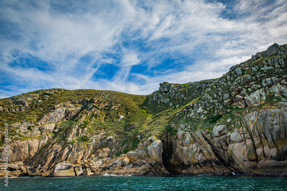Stone rock mountain seascape in Cruising tour view in the Bass Strait at Wilson Promontory Victoria Australia, blue sky and blue sea Stone rock mountain seascape in Cruising tour view in the Bass Strait at Wilson Promontory Victoria Australia, blue sky and blue sea