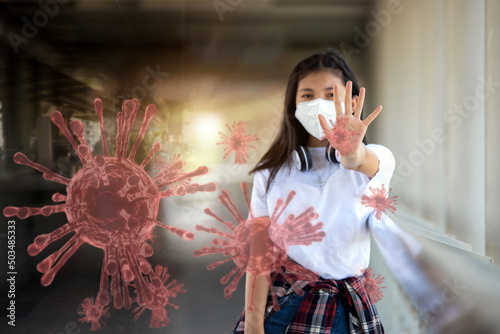 Asian Young Woman student wearing protective mask against coronavirus, covid-19 and stopping hand covid-19 virus pandemic symbol. Campaign to help final protect, declared endemic.