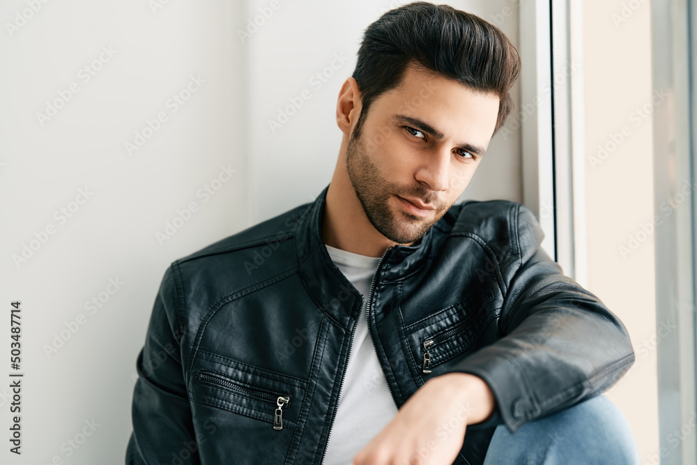 Closeup portrait of handsome trendy man posing on white studio background Closeup portrait of handsome trendy man posing on white studio background