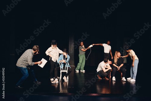 Stage performers practicing act together on stage in class photo