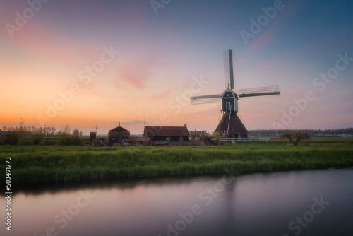 Ancient Windmills at dusk in Kinderdijk in Netherlands