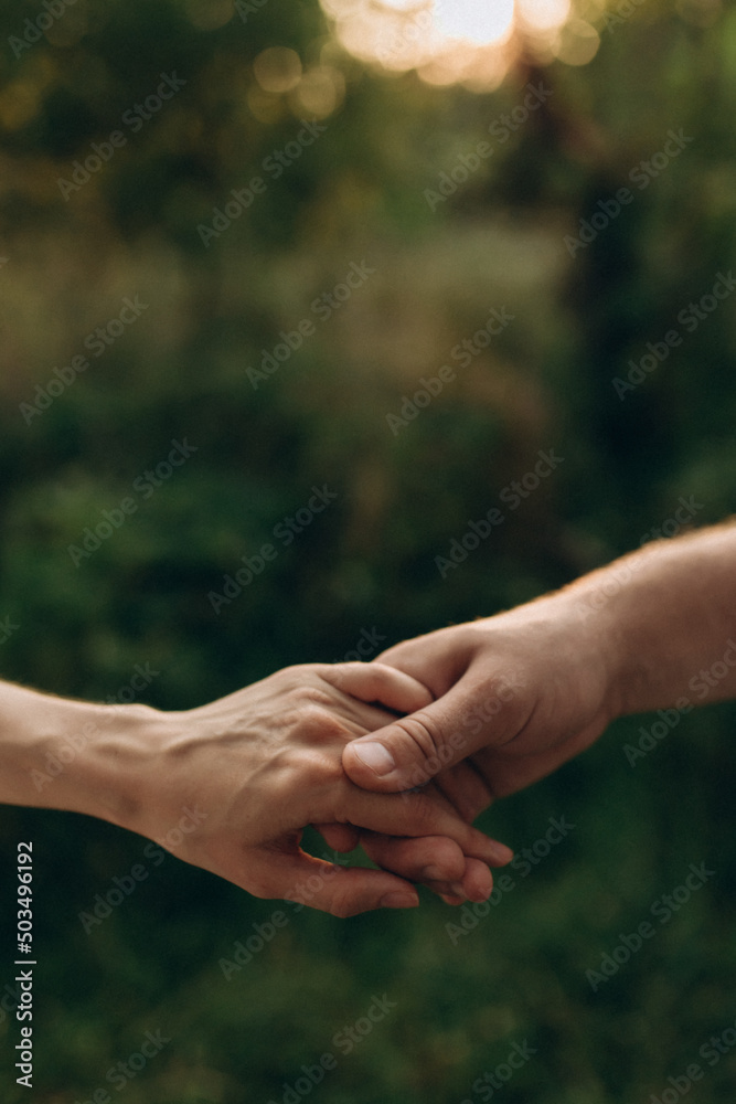 Closeup of loving couple holding hands Closeup of loving couple holding hands