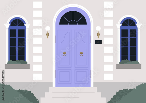 A vintage building entrance with an ornate door and windows