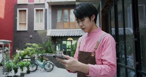 Small business owner man standing with looking at camera posing crossing arm