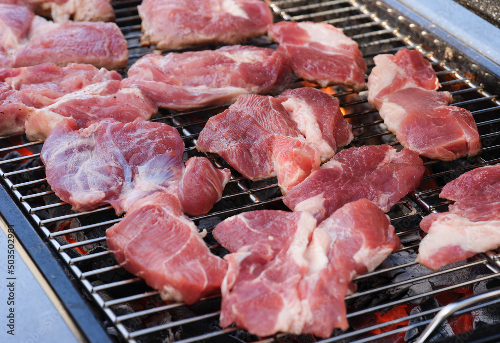 Organic pork meat cooking on a bbq grill