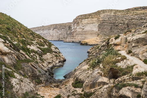Xlendi Bay surrounded by cliffs