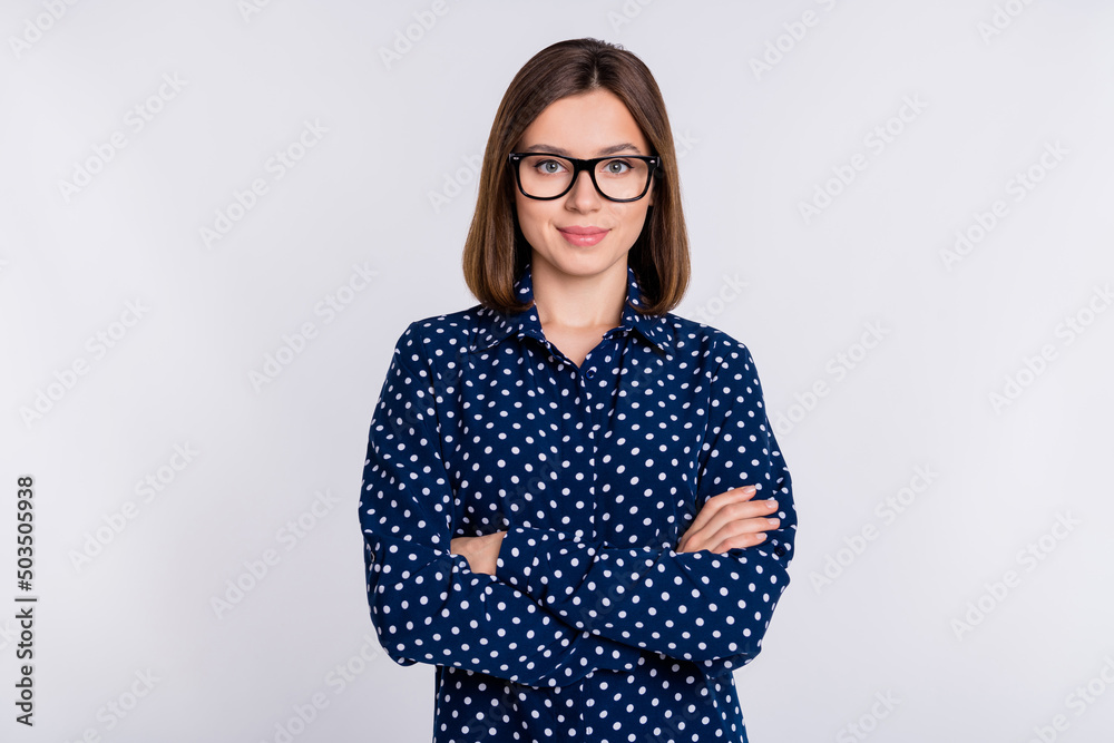 Photo of young charming lady crossed hands manager boss eyewear smart isolated over grey color background Photo of young charming lady crossed hands manager boss eyewear smart isolated over grey color background
