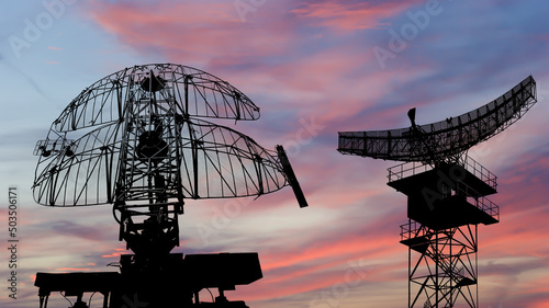 Air defense radars of military mobile anti aircraft systems, modern army industry on the background of the sunset orange sky, Russia