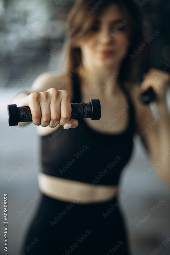 Woman lifting dumbbells at the gym Woman lifting dumbbells at the gym